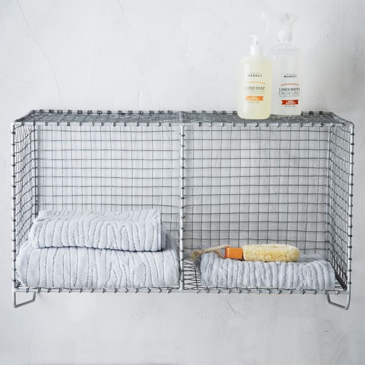 wire basket elevated shelf with towels and toiletries