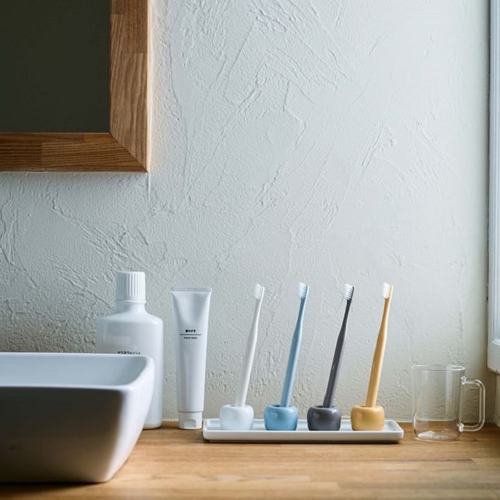 muji porcelain toothbrush holders with toothbrushes 