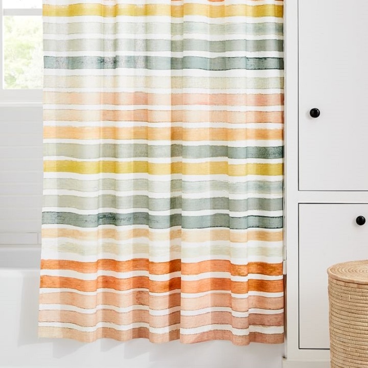 colorful striped shower curtain around tub