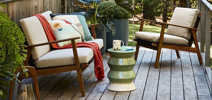 Outdoor lounge chairs, plants and a side table.