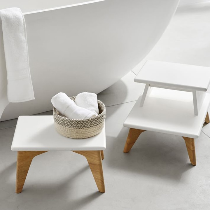 two step stools next to bathtub 