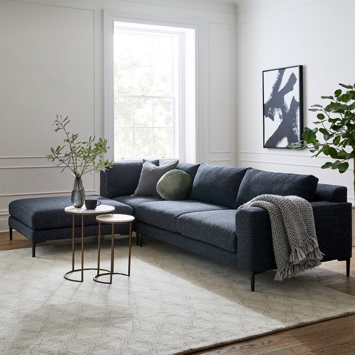 Clean minimal living room with large blue sectional sofa