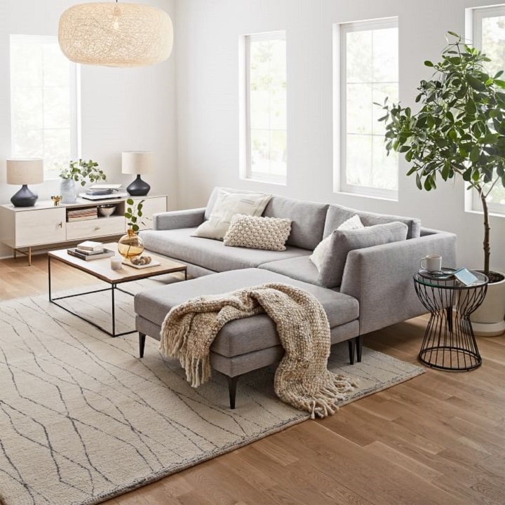 Gray sofa set with throw pillows and blankets in various textures and knits