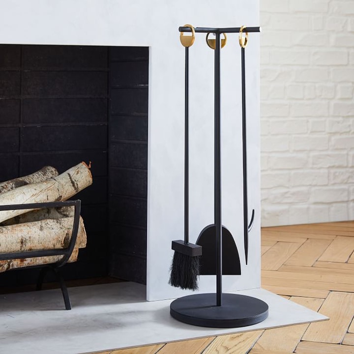black fireplace tools next to modern fireplace