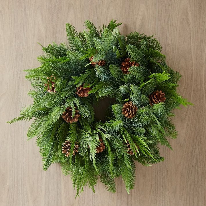 green wreath with pinecones