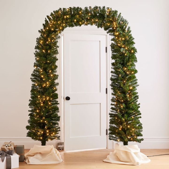 holiday greenery archway around white door