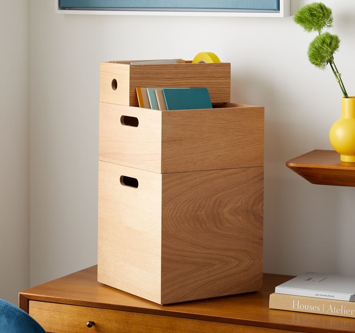 Stackable wooden bins on set of drawers.