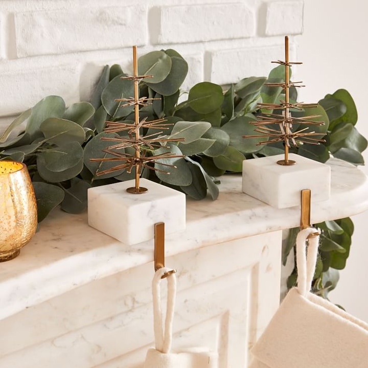 marble and gold stocking holders on mantle