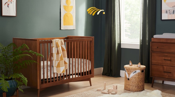 Wood mid-century crib in green nursery Wood mid-century crib in green nursery