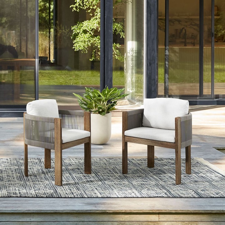 Set of two outdoor, wooden dining chairs.