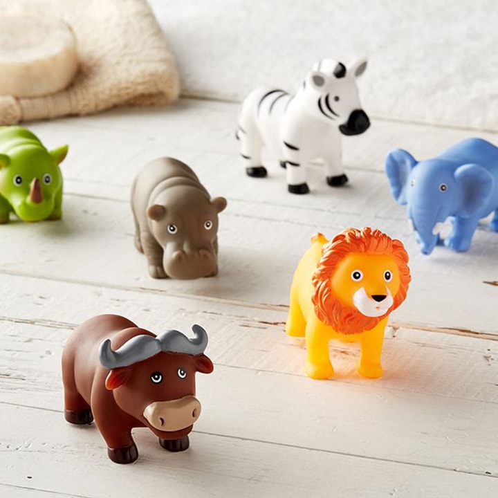 jungle animal squirt toys on wooden floor