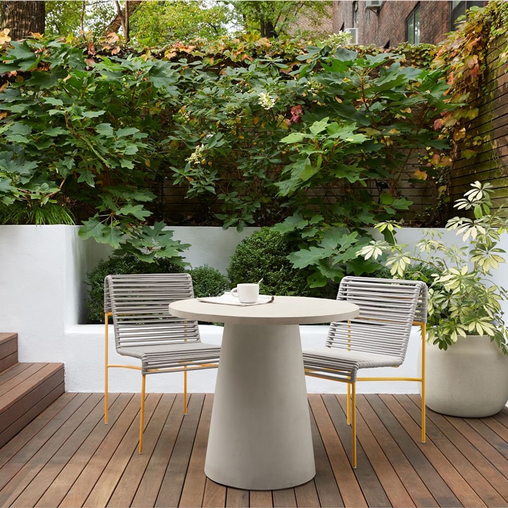 Concrete pedestal outdoor dining table.