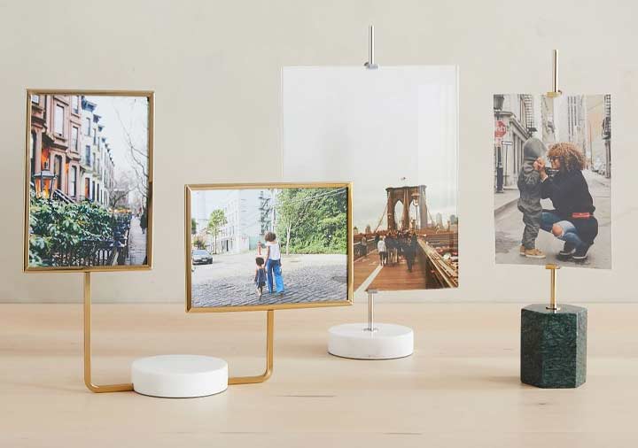 Close up of photo frames with marble bases sitting on table