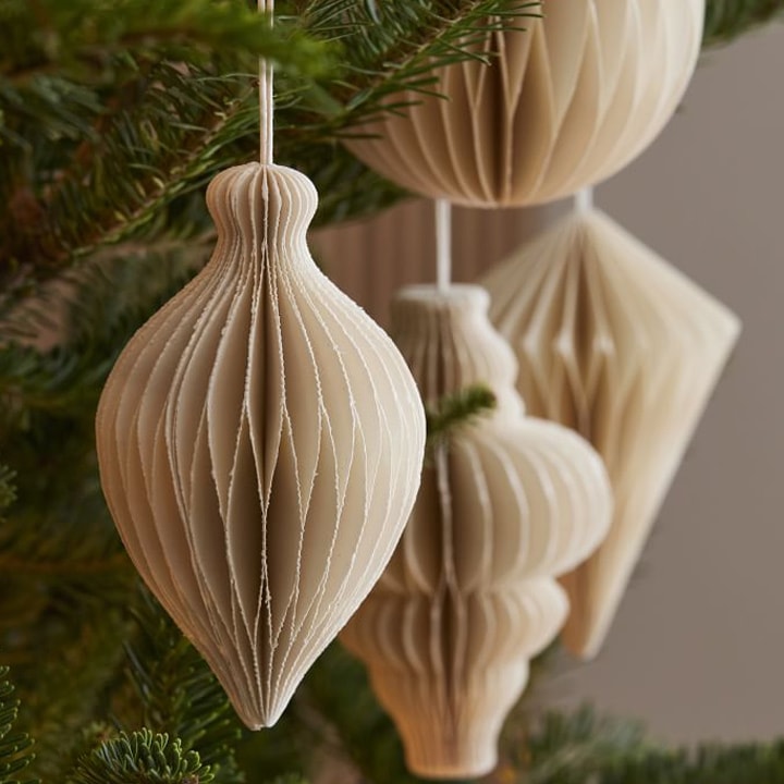 cream paper ornaments on christmas tree