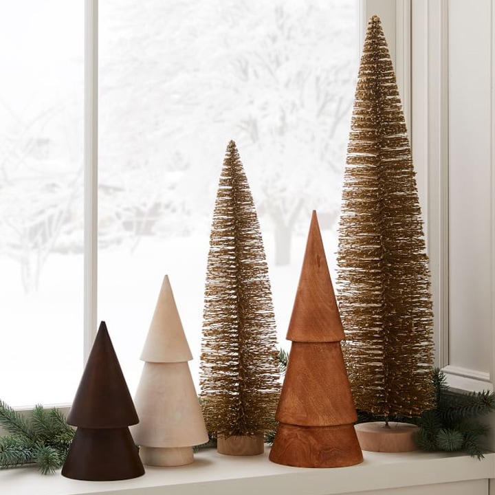 mantle decorated with modern wood christmas tree figures