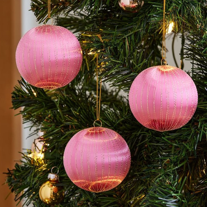 pink and gold ball ornaments on christmas tree