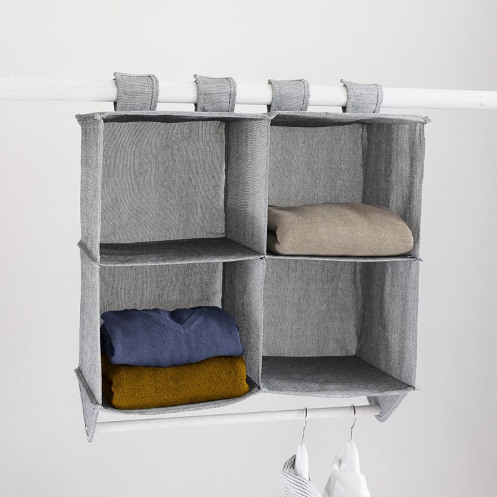 Hanging closet organizer with sweaters.