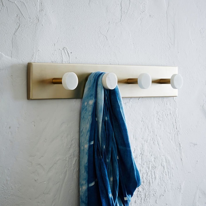 Hook rack with blue hanging garment.
