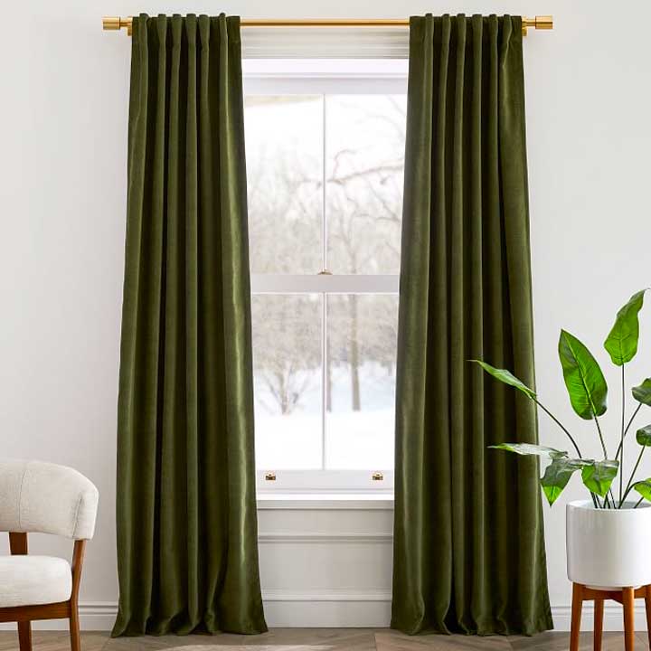green curtains hanging against window and white wall