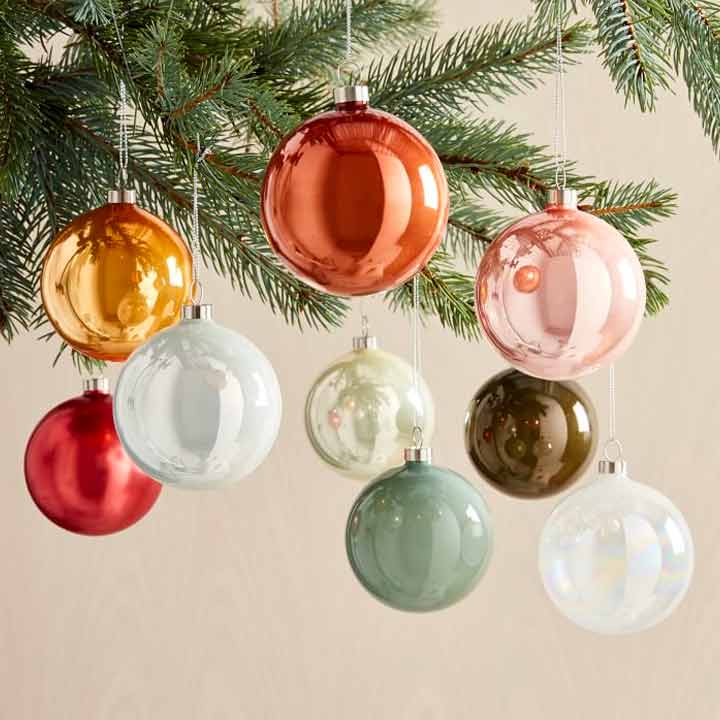close up of multicolored ornaments hanging on tree