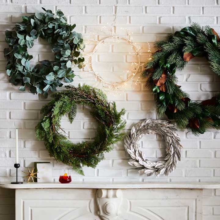 holiday wreaths on white wall