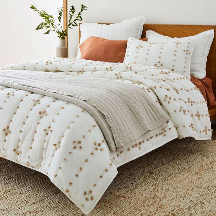 made bed with white decorated bedding