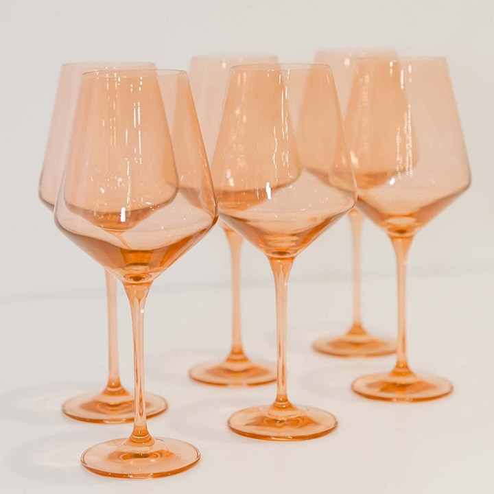 Blush colored stemmed wine glasses.