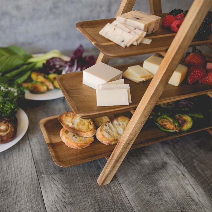 Three-tiered wooden server with appetizers.