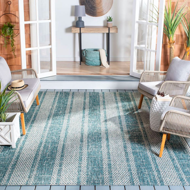 Porch with blue striped outdoor rug.