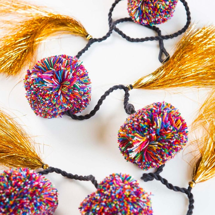 Colorful pom poms with gold tassels.