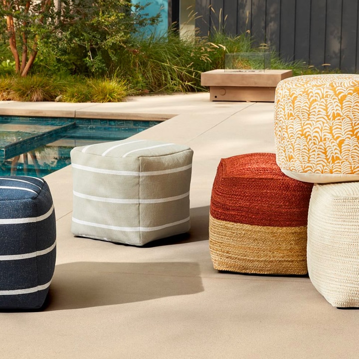 Assortment of woven and colorful poufs.