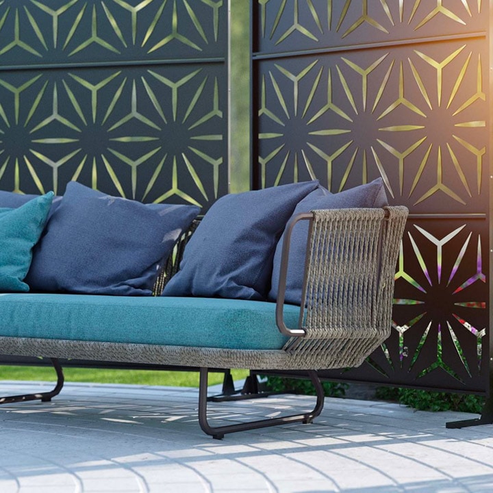 Cutdoor sofa in front of star-patterned privacy screen.