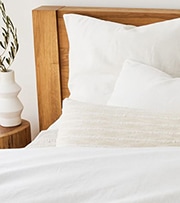 bed with white comforter and pillows