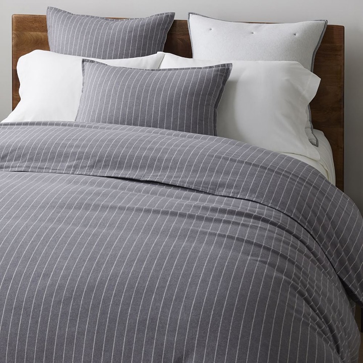 bed with gray pinstripe duvet and pillows