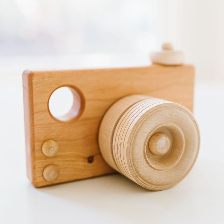 Wooden toy in the shape of a camera
