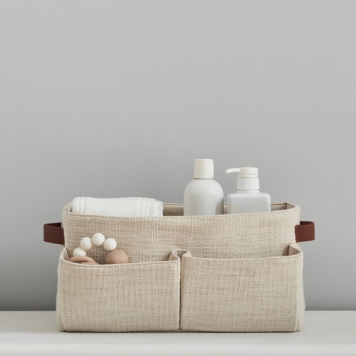 Cotton diaper caddy with changing accessories.