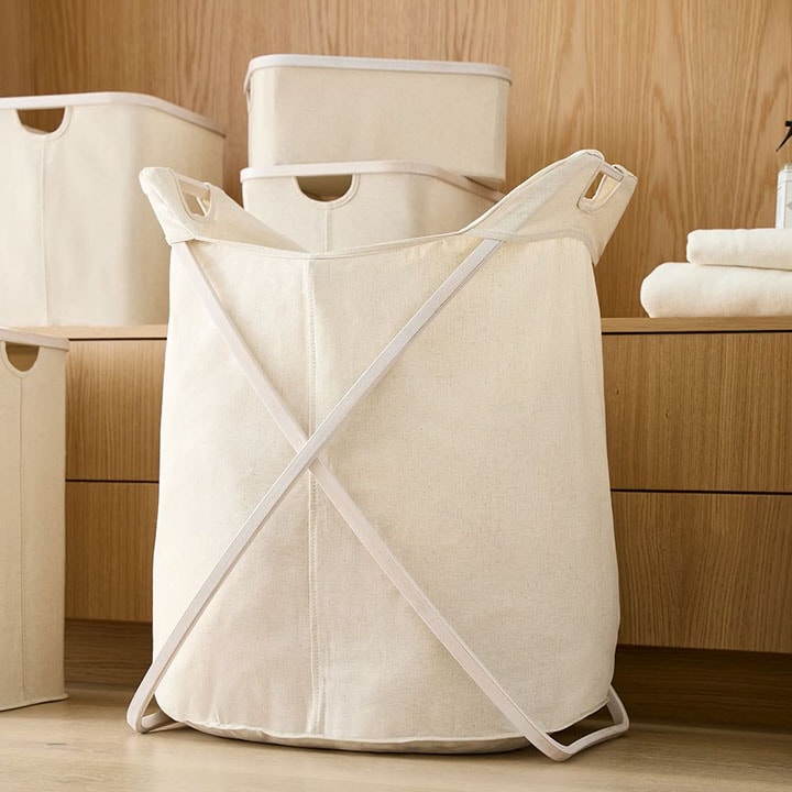 Soft folding closet hamper in natural white.