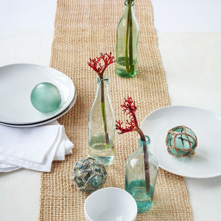 colored glass with woven table runner