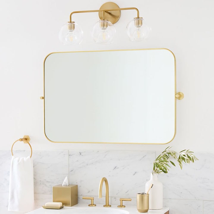 Gold framed rounded rectangle mirror.