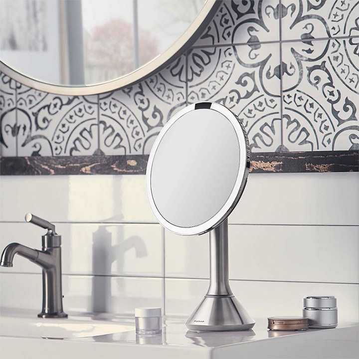 Magnifying vanity mirror on bathroom counter.