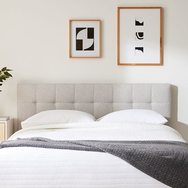Gray grid-tufted headboard in bedroom.