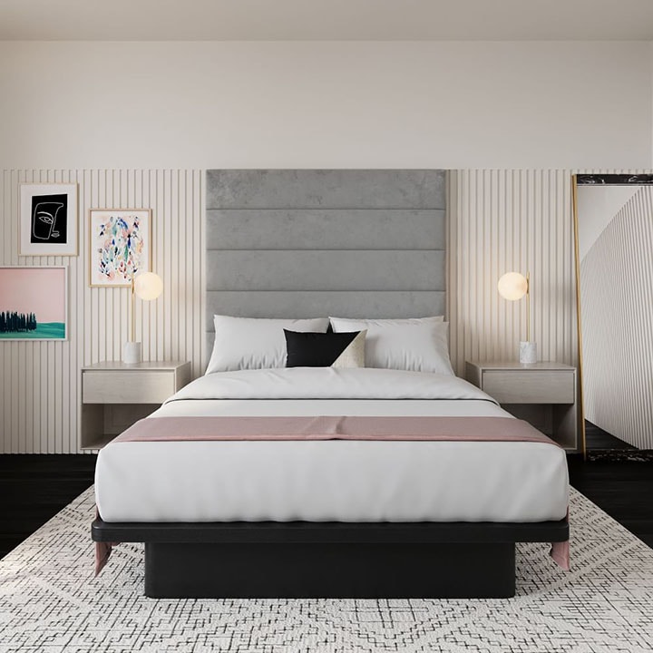 Tall gray upholstered headboard in modern bedroom.