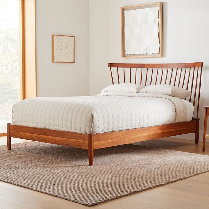 Mid-century spindle bed frame in bedroom.