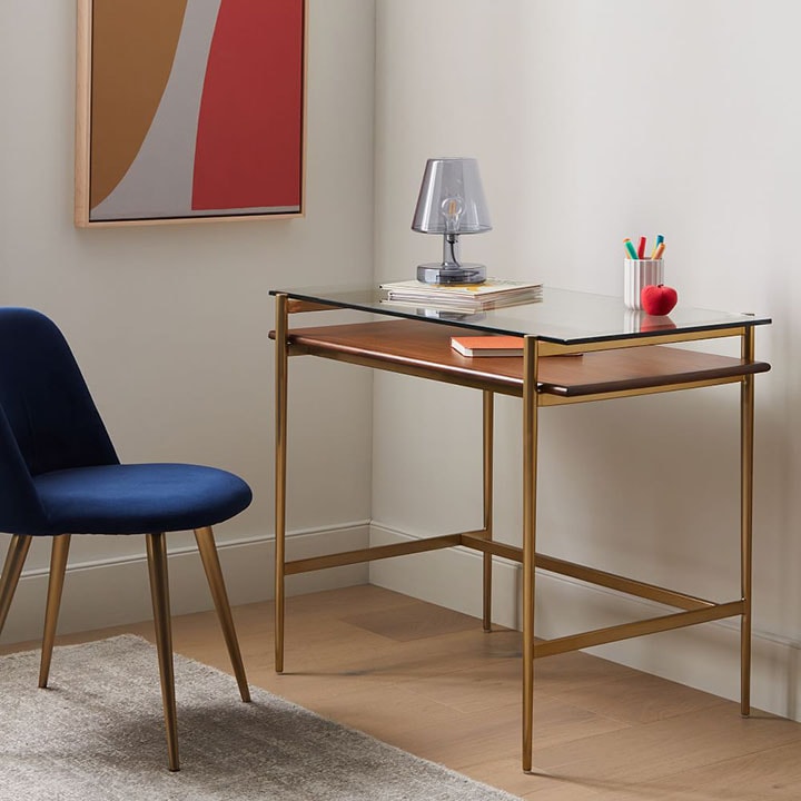 Navy blue chair in front of wood and glass desk table. Navy blue chair in front of wood and glass desk table.