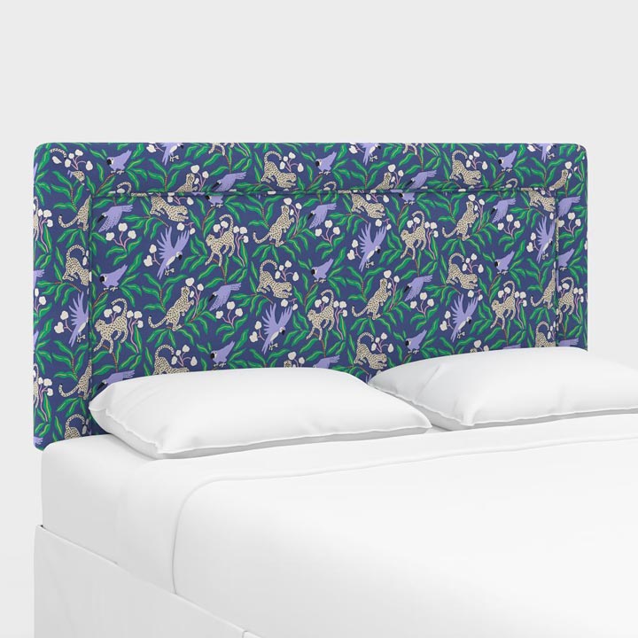 Upholstered Bordered Headboard in a colorful navy kanpur print styled with white bedding. 