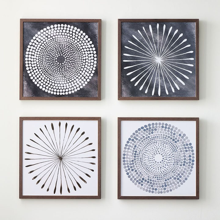  Four assorted watercolor prints hanging on a wall.