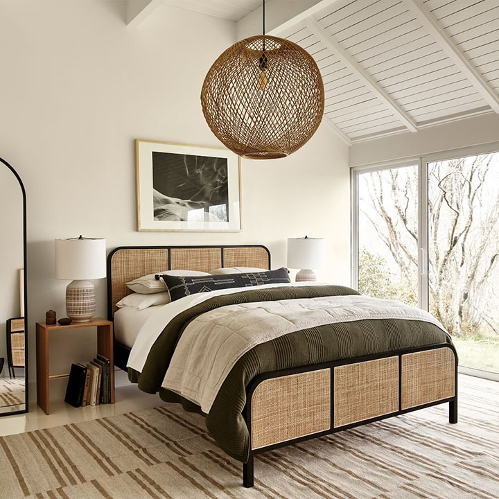 Rattan bed frame in rustic bedroom.