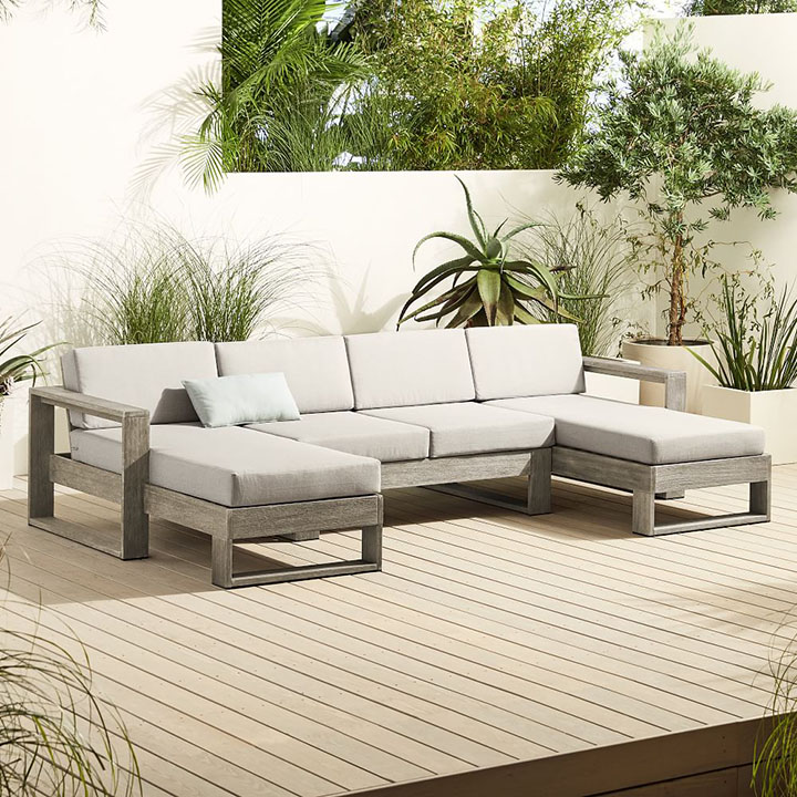 U-shaped outdoor sectional on wood plank floor.