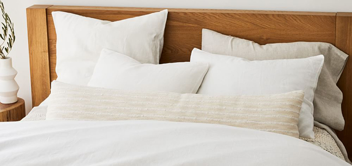 Modern bed with beautiful linen duvet cover and sheet set.