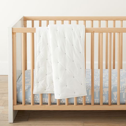 white and natural wood crib
